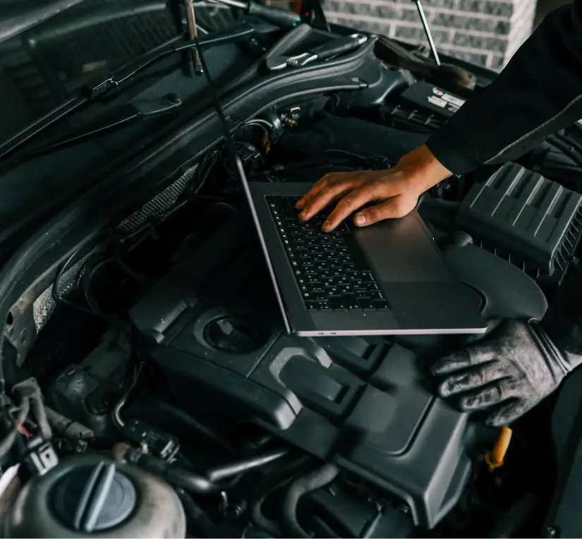 Man checking a car's engine. European car engine diagnostic testing at GB Motors Dallas TX – check engine light service